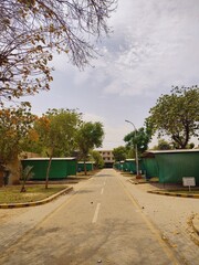 parking area of unilever estate residential area of rahim yar khan, society area road urban city with tree road and cloudy weather