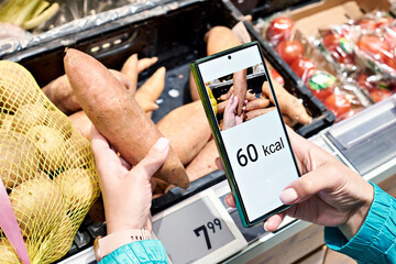Checking calories on sweet potato vegetable with smartphone