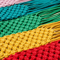 Macrame technique, a square knot of multi-colored threads.