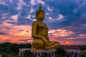 Aerial view of golden big Buddha at Wat Muang located in Ang-thong province of Thailand.