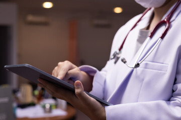 Doctor using or holding ipad in the hospital or clinic, healthcare and medical concept , therapy,...