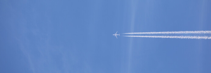 double airplane trail in the blue sky - 786969846