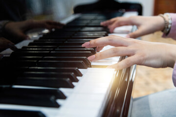 Obraz premium Close up of woman hands playing piano