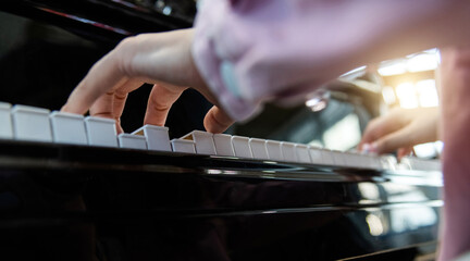 Close up of woman hands playing piano
