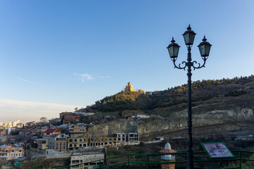 Evening view of Holy Trinity Cathedral of Tbilisi, Georgia from Narikala fortress. Bright sky and...