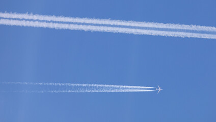 two double airplane tracks in the blue sky - 786974216