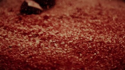 Dramatic impact in the red sand. The impact threw grains of sand into the air