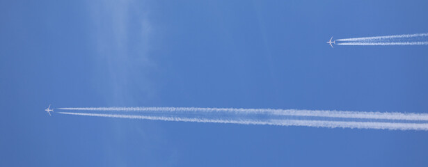 two double airplane tracks in the blue sky - 786974472