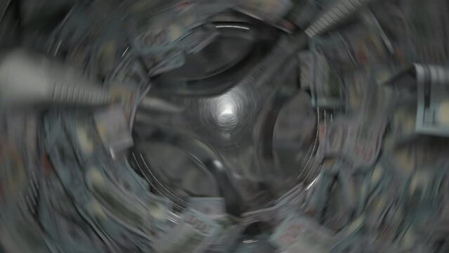 Washing a heap of one hundred dollar bills in washing machine, inside view of drum during spin cycle. Concept of money laundering, financial fraud.