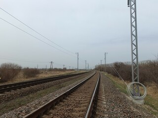 Two way railroad tracks in countryside. Two railway tracks. Cloudy day. Countryside. Fields and...