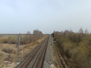 Two way railroad tracks in countryside. Two railway tracks. Cloudy day. Countryside. Fields and...
