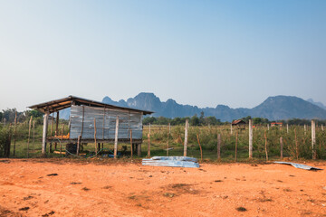 Landscape view of a tin shack in rural Laos