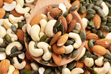 Nuts with pumpkin seeds in woodenware. Various mixed ingredients.