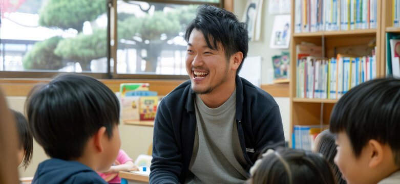 A Japanese male teacher mentors primary school children in a class, sharing knowledge and wisdom.
