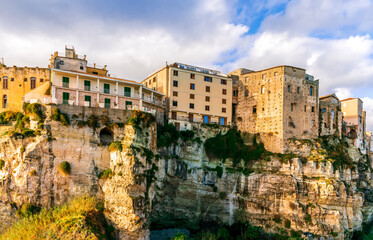 Fototapeta na wymiar scenic travel landscape of beautiful historic town Tropea in Italy with old antique buildings, vintage houses on a high rock cliff above sea and amazing blue sky on background