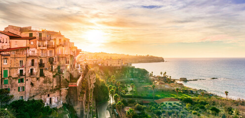 beautiful sunset landscape above sea coastline in Tropea, Italy. Antique buildings on a high rock...