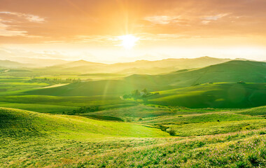 beautiful green valley with green fields with green spring grass with nive hills and mountains and...