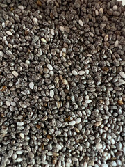 close up black chia seeds black, white and gray textured background image of black chia seeds. small grains But gives high energy and good for health Helps reduce weight