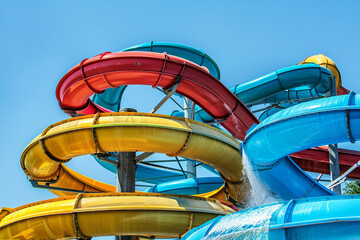 Large water park against the blue sky. Water thrills at the aqua park.