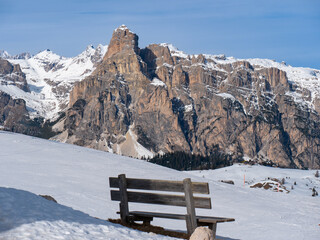 Wooden Bench in Winter Sunny Day in Italian Dolomites Mountains Alps, Italy