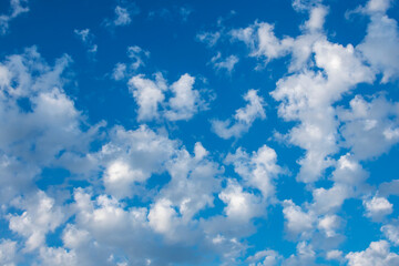 White cumulus clouds on a blue sky.