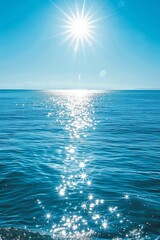 Sun rays illuminating the ocean surface, sparkling water, clear sky, energizing morning
