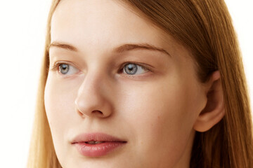 Fototapeta premium Close up photo of woman face with well-kept skin in preorbital zone against white studio background. Prevention of eyebags. Concept of natural beauty, organic cosmetic, spa procedures, face-care.