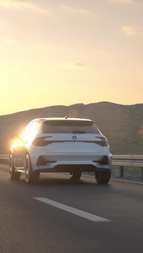 Aerial view of a generic self driving autonomous electric car driving along a desert road in to the sunset. Electric mobility concept. High quality 3d animation rendering. Vertical Video