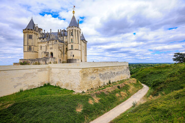 Fototapeta na wymiar Castle Saumur, France, located at the Loire river under a beautiful sunny cloudscape during daytime.