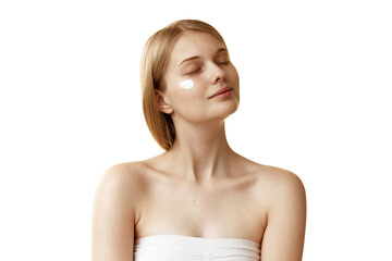 Young woman applying nourishing, moisturizer cream and enjoy her domestic, daily beauty-routine against white studio background. Concept of natural beauty, organic cosmetic, spa procedures, face-care.