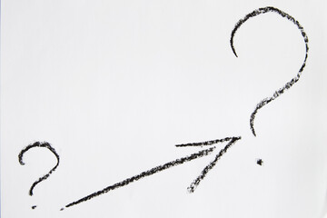Hand-drawn question mark, boldly marked in black on a white sheet of paper, symbolizing the concept...