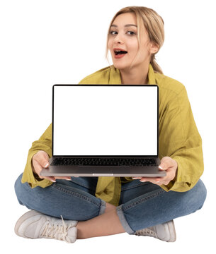 Laptop mock up, young smiling fun caucasian blonde woman hold show laptop mock up. Full body length girl sit floor legs crossed wear casual denim jean and shirt. Show empty blank screen pc computer.