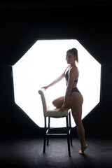 Obraz premium Silhouette of a beautiful young woman wearing underwear in backlight