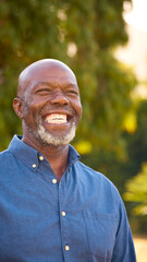 Portrait Of Smiling And Laughing Senior Man Outdoors In Countryside Or Garden