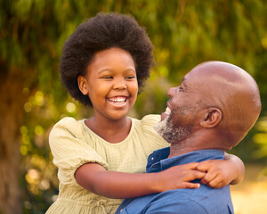 Close Up Of Loving Grandfather Laughing And Hugging Granddaughter Outdoors In Countryside Or Garden