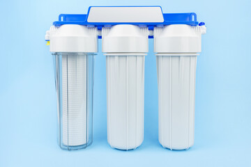 Set three of cartridges for water filter with clear glass of water. Concept of water treatment...