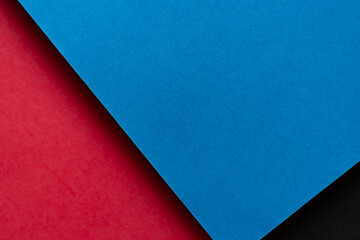 青と赤と黒の重なった画用紙の背景