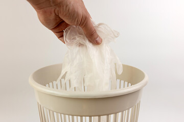 Medical rubber gloves are thrown into the trash. Disposal of household waste.
