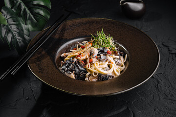 Exquisite asian noodle dish on elegant dark plate