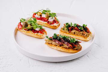 Gourmet bruschetta trio on elegant white plate