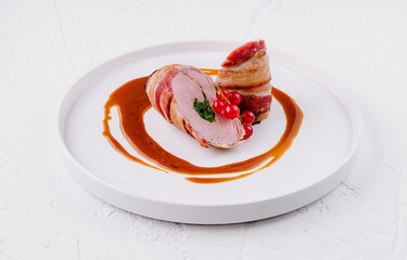 Gourmet pork tenderloin with berry garnish and sauce