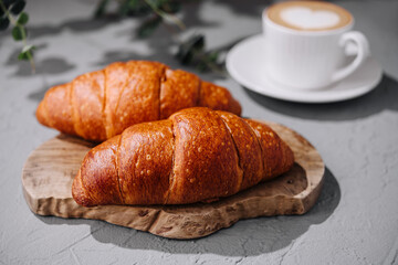 Fresh croissants and coffee on table