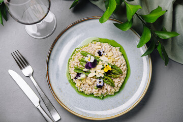 Gourmet risotto with edible flowers on elegant table setting