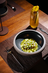 Elegant gourmet dish and cocktail on restaurant table