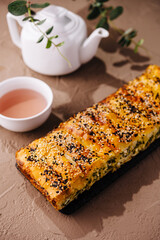 Artisanal sesame seed bread loaf with tea