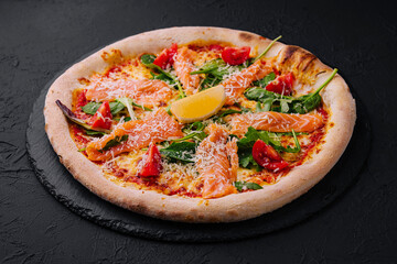 Gourmet smoked salmon pizza on dark background