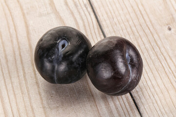 Two ripe sweet black plums