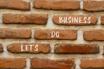 let is do business symbol. Concept words let is do business on beautiful brown brick. Beautiful...