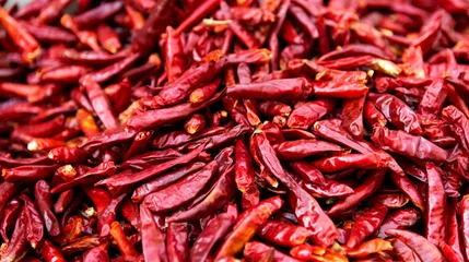 Poster Pile of dry chili peppers in market © xy