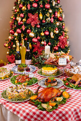 Festive christmas dinner spread with decorated tree